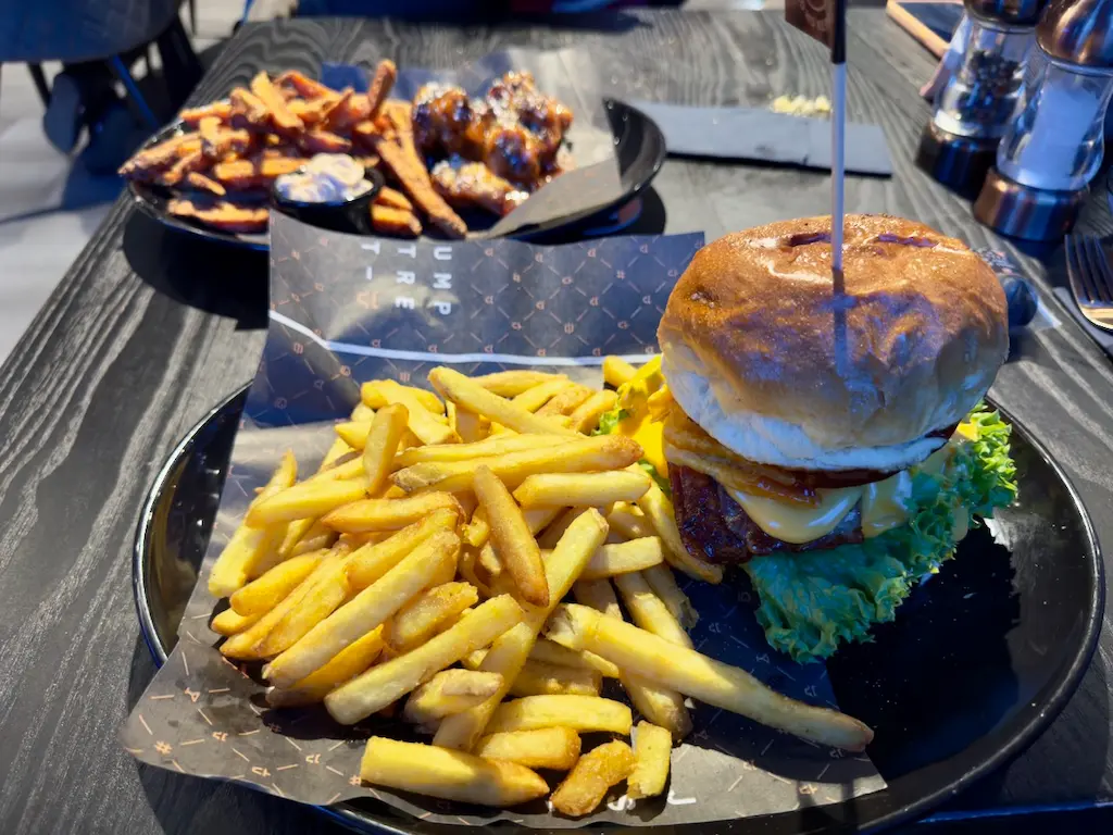 A plate with a cheeseburger and fries.